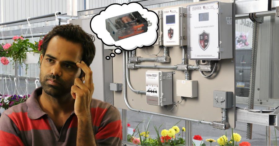 Man thinking in front of greenhouse controllers